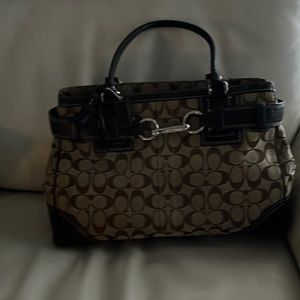 This beautiful Coach purse is large in size.Has pockets. Brown & beige. Classic